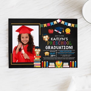 May include: A preschool graduation invitation featuring a photo of a smiling child in a red graduation gown and cap. The invitation has a black chalkboard design with colorful text and illustrations, including owls, books, and a school bus.