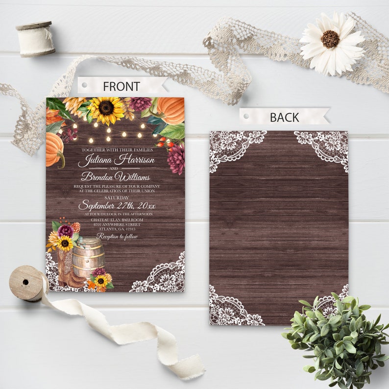 May include: Fall wedding invitation with a rustic wood background and white lace accents. The invitation features a floral design with pumpkins, sunflowers, and leaves. The text reads "Together with their families, Juliana Harrison and Brendon Williams request the pleasure of your company at the celebration of their union, Saturday, September 27th, 20xx, at four o'clock in the afternoon, Chateau Elan Ballroom, 810 Anywhere Street, Atlanta, GA, 12345, Reception to follow."