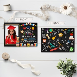 May include: Preschool graduation announcement with a photo of a child in a red cap and gown. The front of the card has the text "KAITLYN'S PRESCHOOL GRADUATION!" and the date. The back features school-themed doodles.