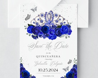 May include: Save the Date card for a Quinceañera, featuring a blue and silver crown with blue flowers and butterflies. The text reads "Save the Date for the Quinceañera - honoring - Gabriella Delgado 10.25.2024 VALLEJO, CA Formal invitation to follow."