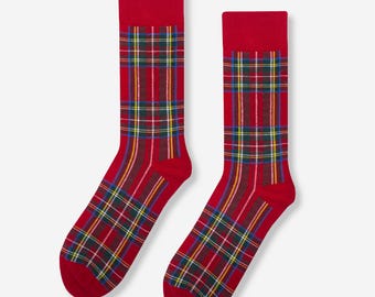 May include: A pair of red socks with a plaid pattern in shades of red, green, yellow, and blue.