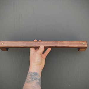The wooden towel bar