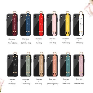 May include: A collection of clear phone cases with various colored straps. Each strap features the text "love. Linne" and comes in colors like red, blue, pink, yellow, white, black, green, and more. The cases are displayed against a white background.