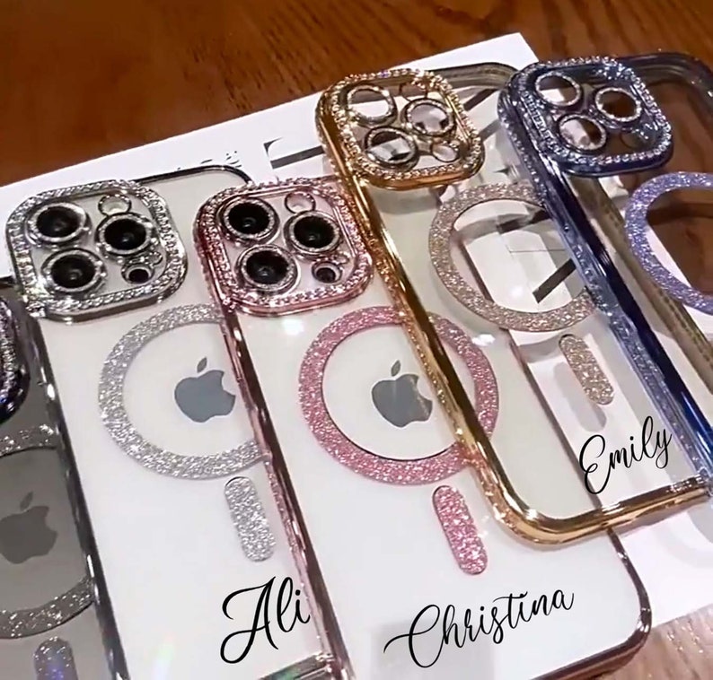 Op de afbeelding: Vier transparante telefoonhoesjes met strass en een ringhouder. De hoesjes zijn versierd met verschillende gekleurde strass en hebben de namen "Ali", "Christina", "Emily" en een vierde hoesje zonder naam.