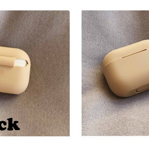 May include: A beige silicone case for AirPods with a gold chain attached. The case has a small opening on the top for charging. The back of the case is shown in the image, with the word "back" printed below it.