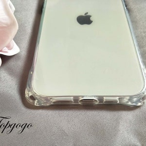 May include: A clear phone case with a raised edge around the screen and camera. The case is designed to fit a smartphone with a large screen and a single camera lens. The case is made of a clear, flexible material that is designed to protect the phone from scratches and bumps.