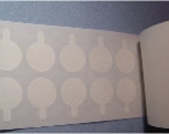 May include: A sheet of white, round, adhesive stickers with a small tab on each sticker. The stickers are arranged in rows.