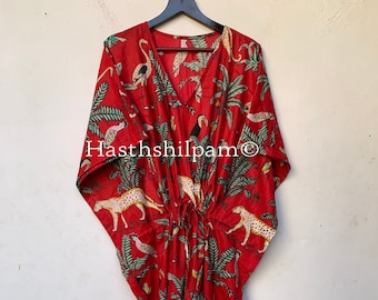 May include: Red kaftan with a V-neck and a drawstring waist. The fabric features a repeating pattern of white and yellow leopards, green palm trees, toucans, and zebras. The text "Hasthshilpam" is visible on the front.