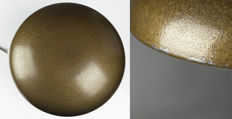 May include: A close-up of a gold-colored lampshade with a textured surface. The lampshade is round and has a slight curve to it.