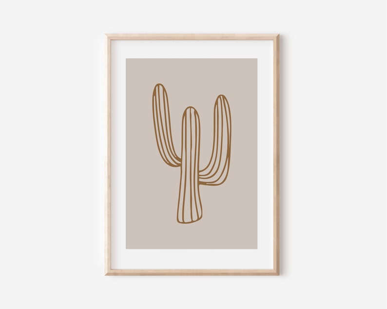 May include: A minimalist art print featuring a brown line drawing of a cactus on a light beige background. The print is framed in a light wood frame.