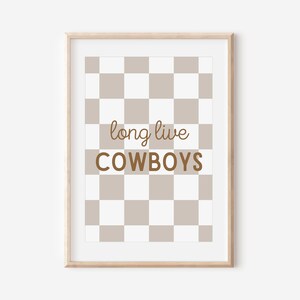 May include: A framed print with a brown and white checkered background. The text "long live cowboys" is written in brown text on the print.