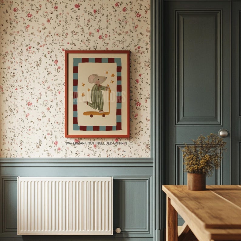 May include: Framed print of a cartoon mouse on a scooter. The mouse is dressed in a striped outfit, set against a cream background with a red and blue checkered border. The frame is reddish-brown. The print is on a floral wallpaper.