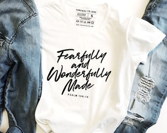 May include: White t-shirt with black text that reads "Fearfully and Wonderfully Made" with the scripture reference "Psalm 139:14" underneath.