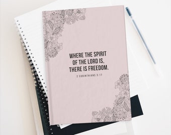 May include: A pink journal with a floral design and the quote "Where the spirit of the Lord is, there is freedom."  2 Corinthians 3:17 is printed on the cover.