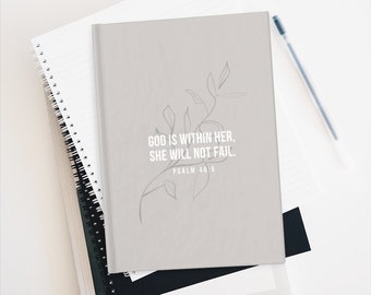 May include: A gray journal with a simple line drawing of a branch with leaves. The text "God is within her, she will not fail. Psalm 46:5" is printed on the cover.