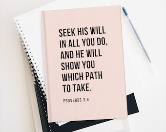 May include: A pink notebook with the text "SEEK HIS WILL IN ALL YOU DO, AND HE WILL SHOW YOU WHICH PATH TO TAKE. PROVERBS 3:6" printed on the cover.
