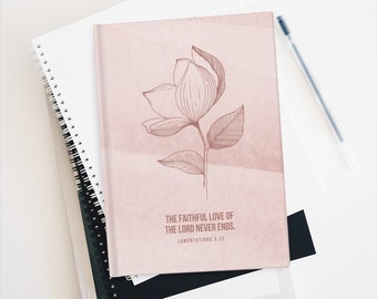 May include: A pink journal with a floral design and the quote "The faithful love of the Lord never ends. Lamentations 3:22"