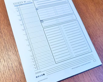 May include: A white printable daily planner with a section for daily tasks, a section for notes, and a section for gratitude. The planner has a simple design with black lines and a small phone icon.