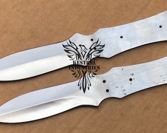 May include: Two silver knife blades with a rounded tip and a Kestrel Industries logo etched on the surface.