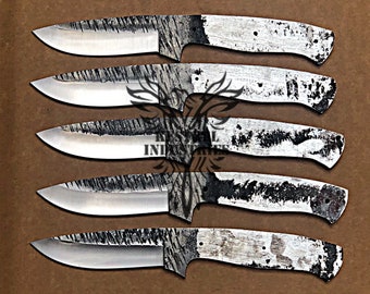 May include: Five unfinished, silver-colored, knife blades with black markings. The blades are arranged in a row, with the handles facing up.