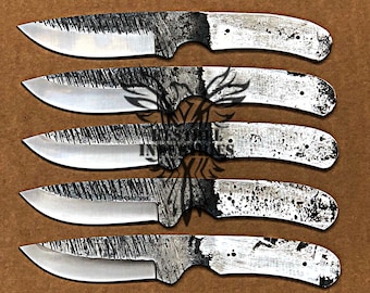 May include: Five unfinished knife blades with textured, silver-colored blades and white handles. The blades have a rough, etched appearance, and the handles show a speckled pattern. The knives are arranged in a vertical stack.