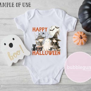 May include: White baby onesie with a graphic of three witches and a ghost. The text "Happy Halloween" is printed in orange below the graphic.