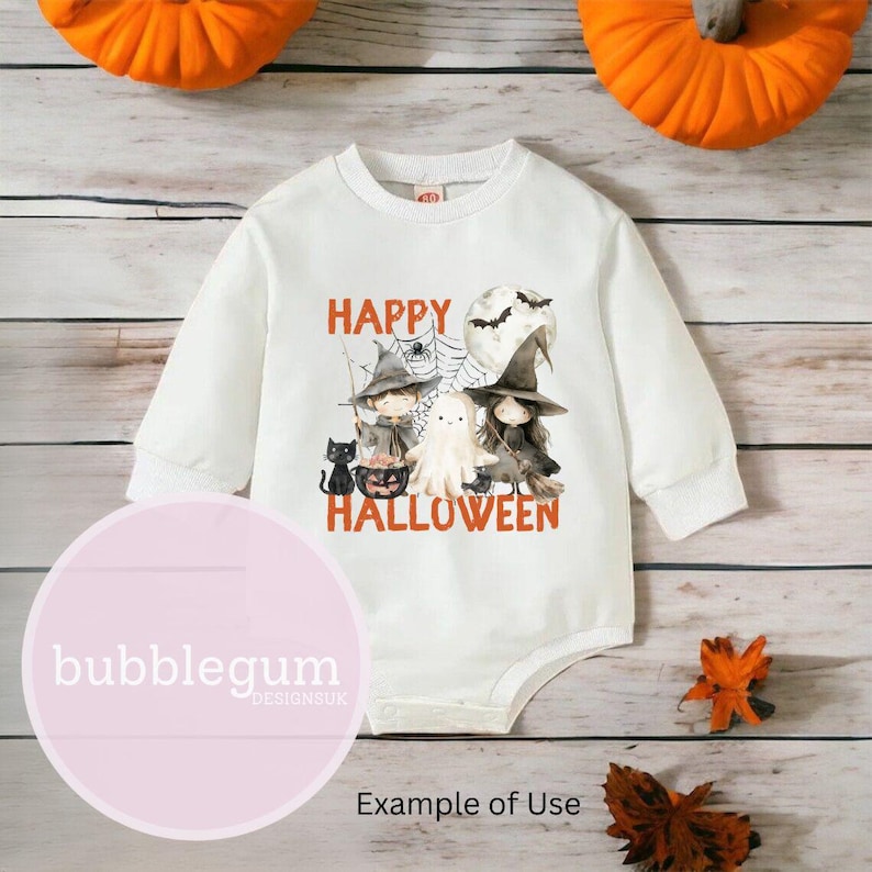 May include: White long-sleeved baby onesie with a graphic print of a ghost, two witches, a black cat, and a pumpkin. The text "Happy Halloween" is printed in orange on the onesie.
