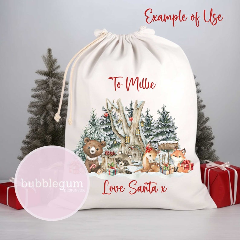 May include: A white canvas Christmas gift bag featuring a woodland scene with a bear, raccoon, deer, and fox. The bag is personalised with the text "To Millie" and "Love Santa x".