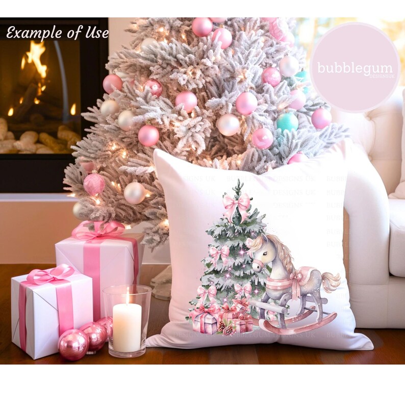 May include: A white pillow with a pink and green Christmas tree and a rocking horse with a pink bow. The pillow is sitting on a couch in front of a fireplace and a Christmas tree.