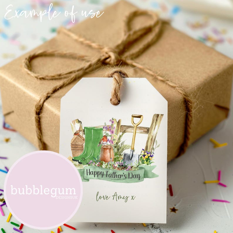 May include: A white gift tag with a watercolor illustration of gardening tools, including a pair of green rain boots, a shovel, and a rake. The tag has the text "Happy Father's Day" and "love Amy x".