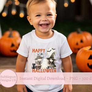 May include: A white t-shirt featuring a graphic of a ghost, witches, and a black cat. The text "Happy Halloween" is printed on the shirt. A young child is wearing the shirt.