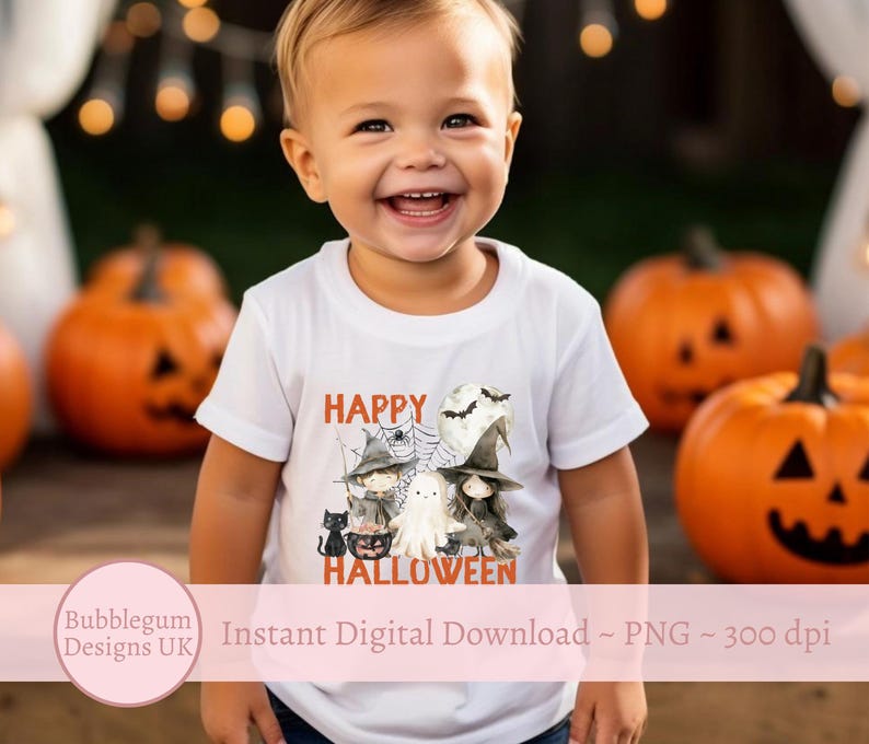 May include: A white t-shirt featuring a graphic of a ghost, witches, and a black cat. The text "Happy Halloween" is printed on the shirt. A young child is wearing the shirt.