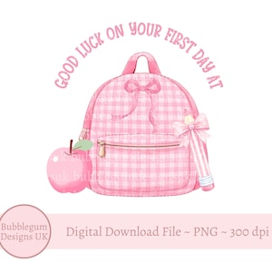 May include: A pink gingham backpack with a bow, a pink apple, and a pencil with a bow. The text "GOOD LUCK ON YOUR FIRST DAY AT" is arched above the backpack. The image is a digital download.