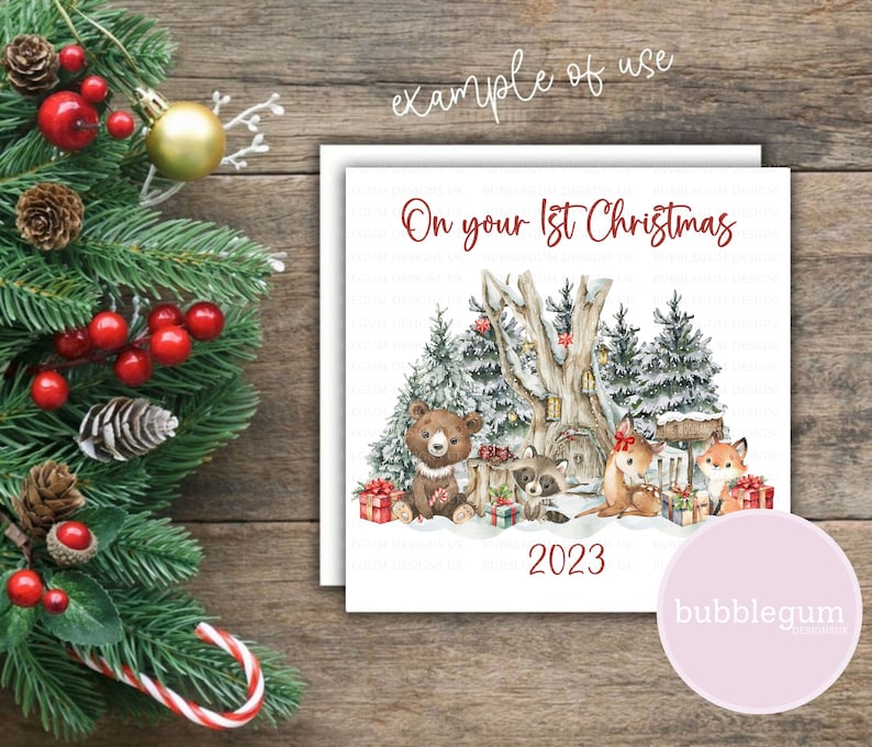May include: A white card with a winter woodland scene featuring a bear, raccoon, and two foxes. The card says "On your 1st Christmas 2023" in red text.