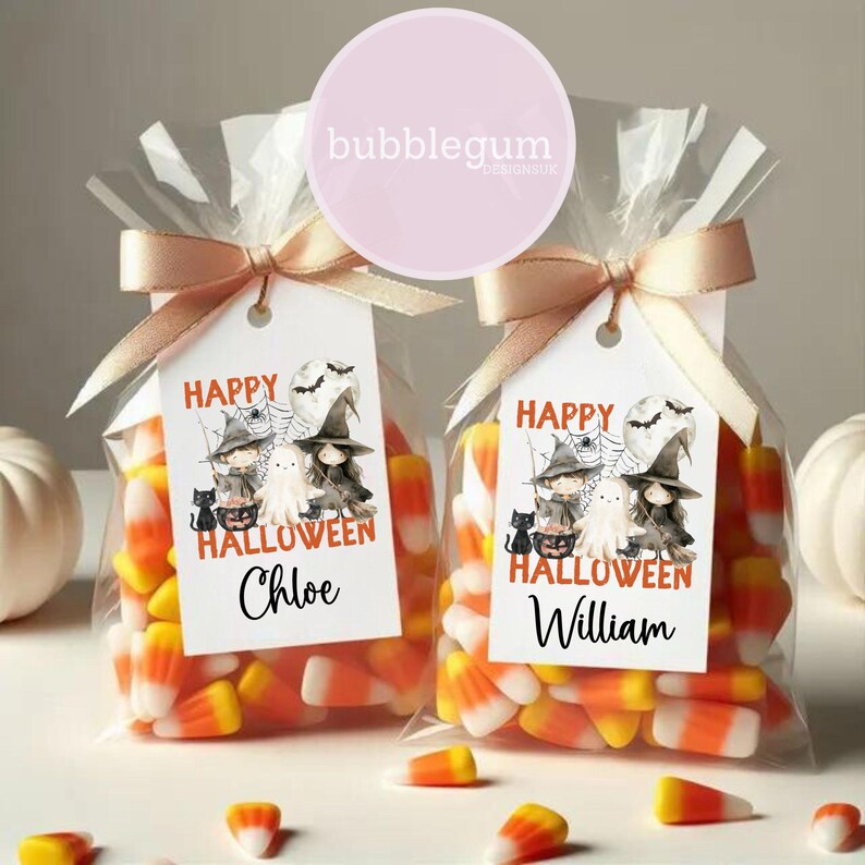 May include: Two clear cellophane bags filled with orange and white candy corn. Each bag has a white tag with a cartoon image of witches and a ghost. The tags say "Happy Halloween" and are personalised with the names "Chloe" and "William".