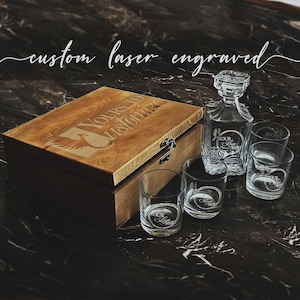 May include: A wooden box with a laser engraved design that says "Yours to Customize" and a set of four clear glass whiskey glasses and a decanter.