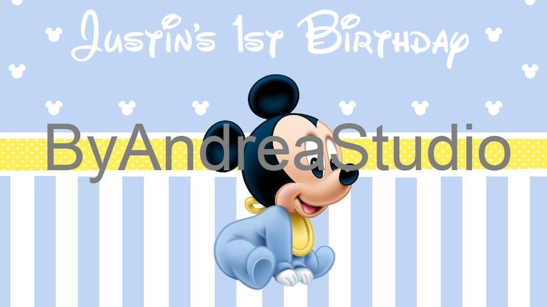May include: A blue and yellow birthday banner with a cartoon baby Mickey Mouse. The banner says "Justin's 1st Birthday" and "By Andrea Studio".