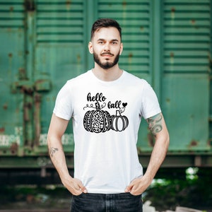 May include: White t-shirt with a black graphic of two pumpkins and the text "hello fall" with a heart.