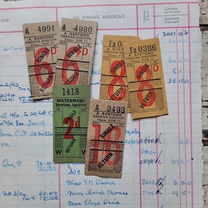May include: A collection of vintage bus tickets and a ledger page. The tickets are rectangular with red and green text, featuring the words "Single" and "Return." The ledger has handwritten entries and columns.