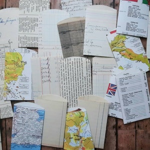 May include: A collection of vintage paper ephemera, including maps, receipts, and handwritten notes. The papers are in various shades of brown, white, and green. The papers are arranged in a random pattern on a wooden surface.