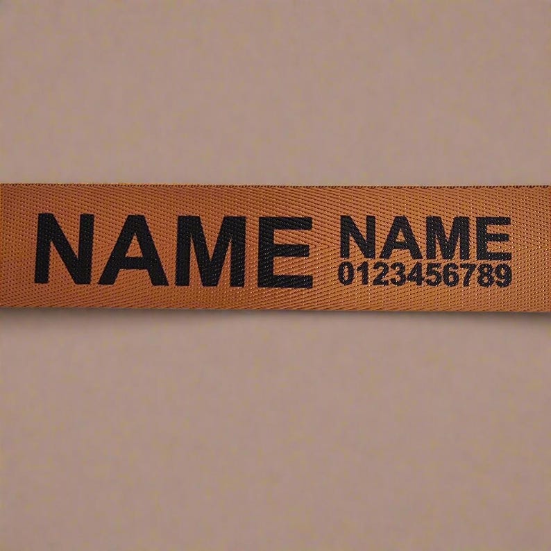 a brown label with the word "NAME" printed on it, along with a phone number.