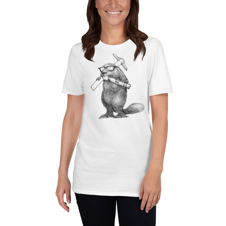 May include: White t-shirt featuring a detailed black and white illustration of a beaver wearing glasses and holding a pickaxe and a rolled-up document. The beaver is standing upright. The shirt is a classic crew neck style.