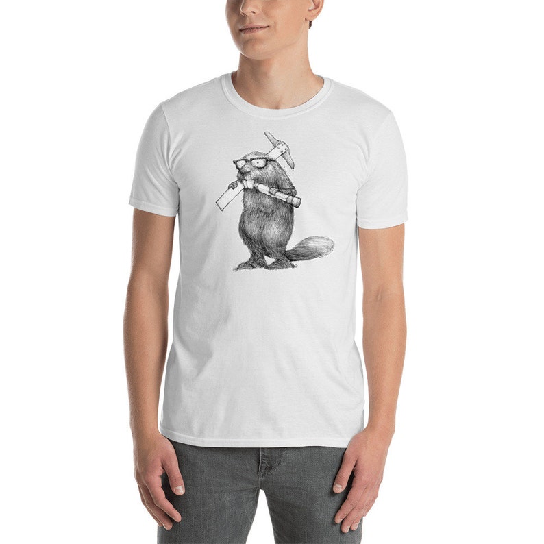 May include: White t-shirt featuring a black and white illustration of a beaver wearing glasses and holding a pickaxe and rolled-up papers. The beaver is standing upright. The shirt is made of a soft material.
