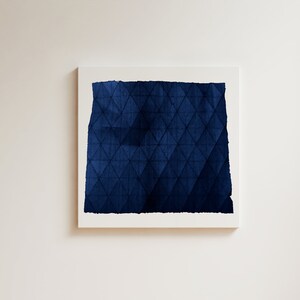 May include: A framed abstract painting with a dark blue geometric pattern. The pattern is made up of triangles and squares.