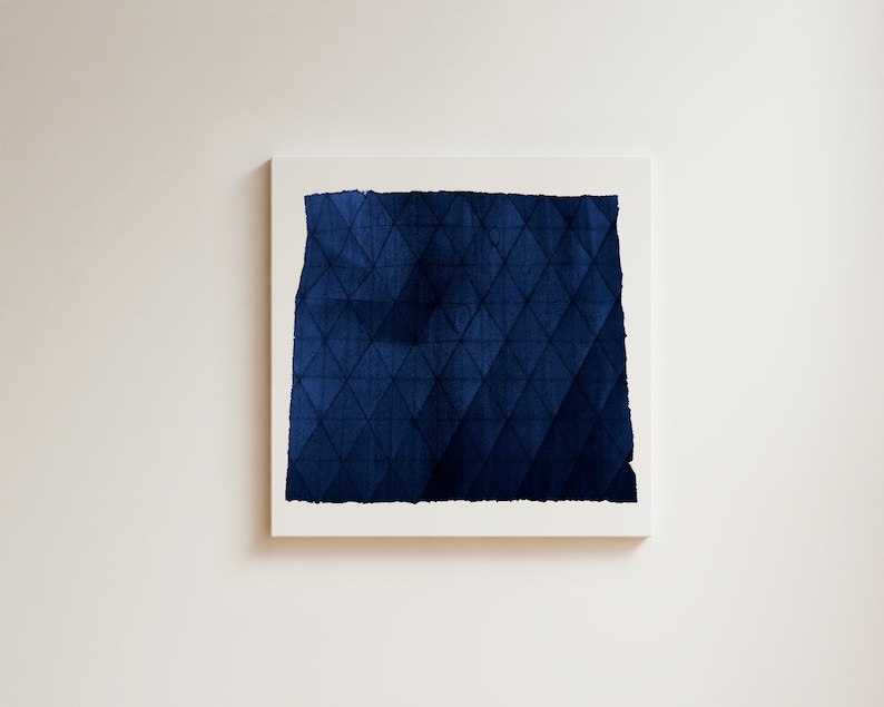 May include: A framed abstract painting with a dark blue geometric pattern. The pattern is made up of triangles and squares.