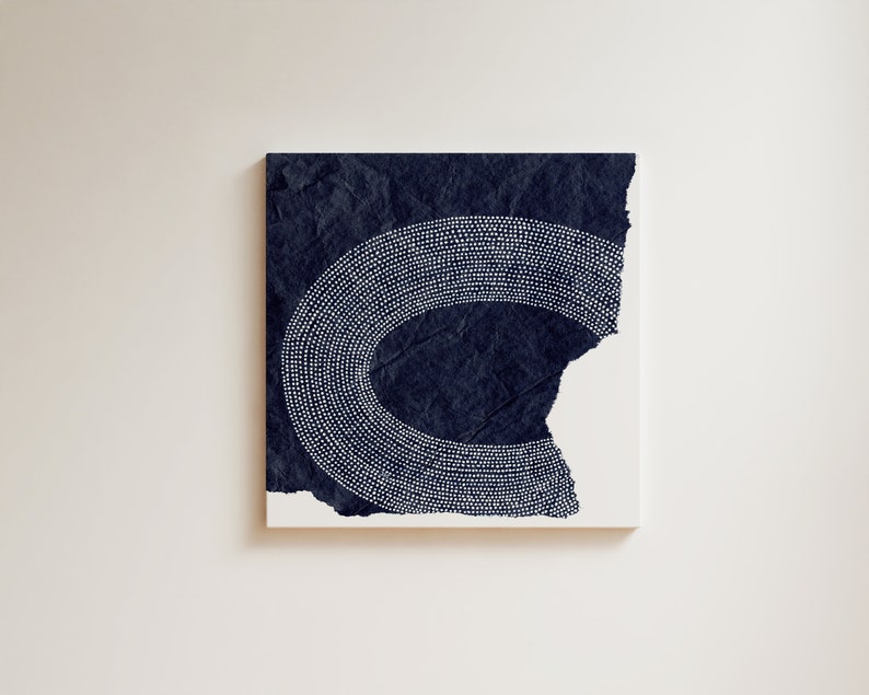 May include: A dark blue canvas painting with a white dotted design in the shape of a crescent moon.
