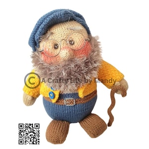 May include: A knitted toy gnome wearing a blue hat, yellow jacket, and blue pants. The gnome has a brown beard, brown shoes, and a stick in its hand. The gnome is holding a stick in its hand. The gnome is smiling.