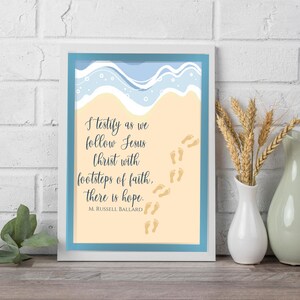 May include: A framed print featuring a beach scene and a quote by M. Russell Ballard: "I testify as we follow Jesus Christ with footsteps of faith, there is hope."