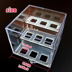 May include: A clear acrylic display case with a size of 17cm by 6.8cm by 3cm. The case has two shelves and is perfect for displaying small items.