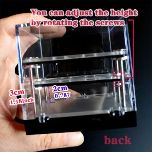 May include: A clear acrylic case with two adjustable shelves. The shelves are held in place by screws that can be rotated to adjust the height of the shelves. The case is 3 inches (7.62 cm) tall and the shelves are 2 inches (5.08 cm) apart.